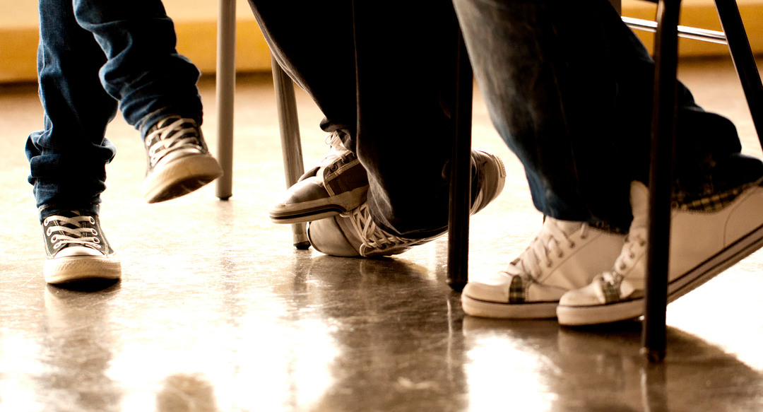 View of some teenager legs on a classroom.
